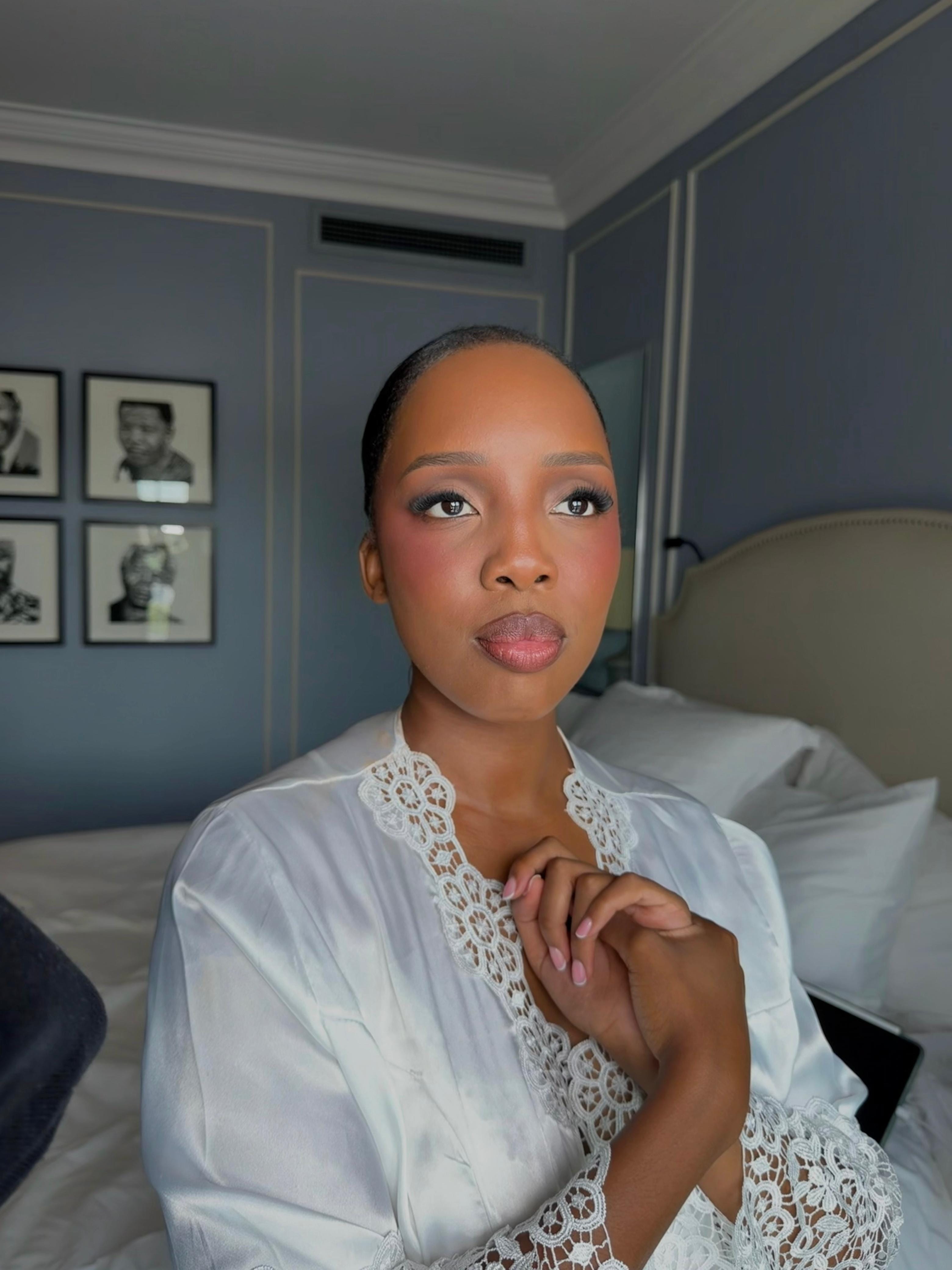 Bride in elegant lace robe — bridal makeup